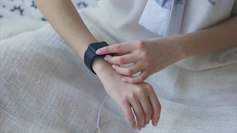 Close up shot of female hand who uses a gift from parents - smart watch. Stock Footage
