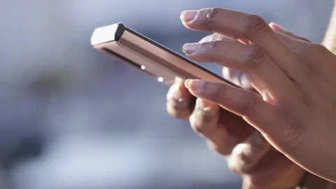 Close shot of female hands using a touch screen cell phone outdoors in the city  Stock Footage 252412529