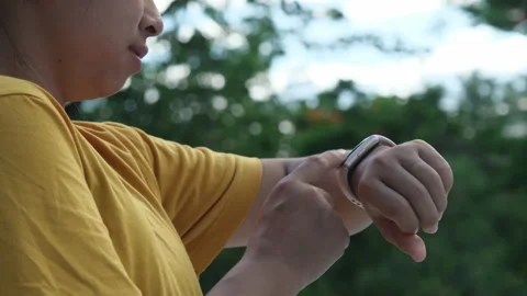Close-up shot of a female runner counting calories burned on a smart watch. Stock Footage 200088074