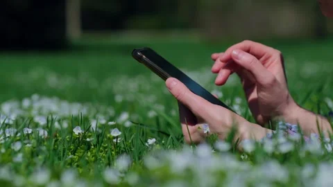 Close-up shot of female's hands while using a smartphone outdoors. 스톡 동영상 276351380