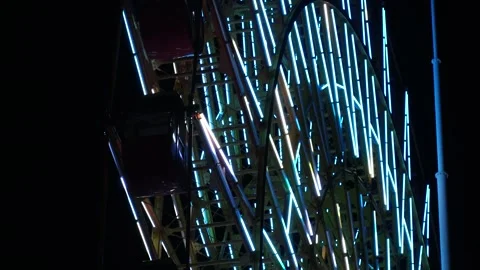 Close up shot of ferris wheel at night. Colorful led neon light decoration. Video stock 279364275