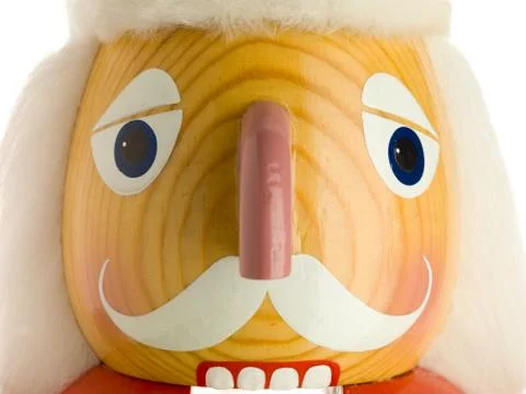 Close shot of a festive nutcracker's face on white. Stock Photos