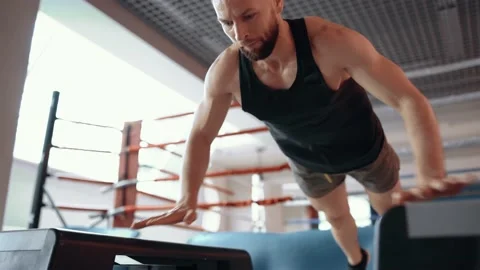 Close-up shot, filmed on one side, of the young sportsman doing push-ups Stock Footage 156850073