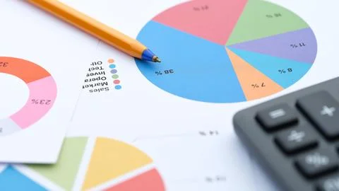 A close-up shot of financial documents featuring colorful pie charts Stock Photos