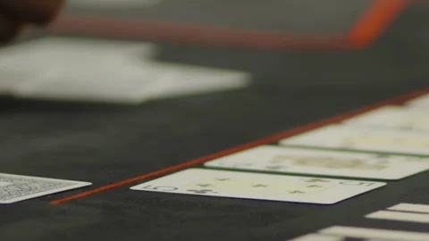 A close-up shot of fingers touching community cards on table Stock Footage 336237737