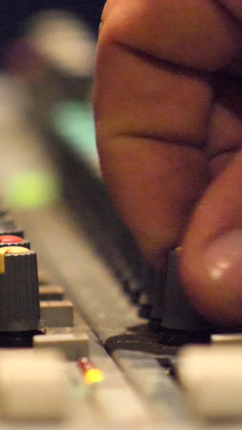 Close shot of fingers turning button on recording studio mixing console Stock Footage 230665219