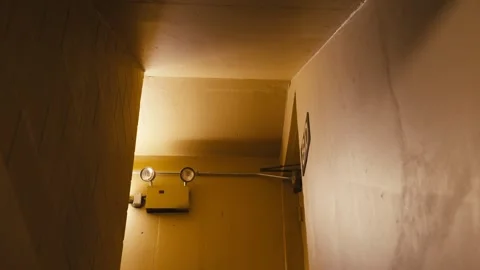 Close-up shot of fire exit lights in a hallway, which will illuminate in case of 動画素材 323102037