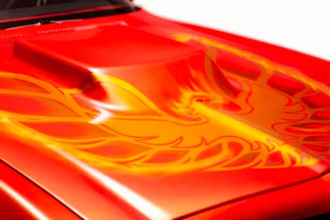Close up shot of Firebird pattern on the engine hood of the orange colored 19 Stock Photos