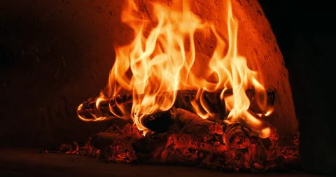 Close-up shot of firewood burning in a stone oven in a restaurant's bakery to Stock Footage 248570627