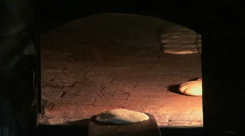 Close up shot of flat bread baking in a stone oven Stock Footage 47808093