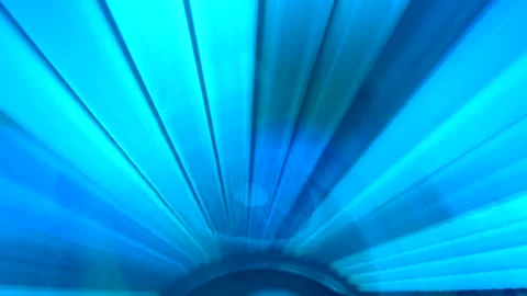 Close up shot of flicker and flashing blue lights of solarium tanned bed. Vídeos de archivo 156585071
