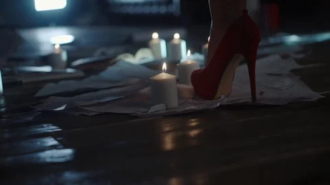 Close shot on the floor with paper on which there is a woman in high shoes Stock-Footage 88407766