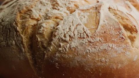 Close up shot of flour on bread in slow motion Stock Footage 153466223