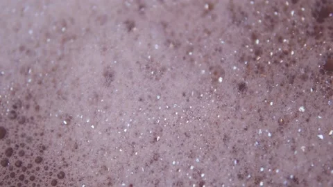 Close up shot of foam and soapy bubbles on a moving water surface, self care Stock Footage 307592161