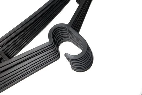 Close-up shot focusing on a neat stack of dark grey or black plastic clothe.. Stockfoto's