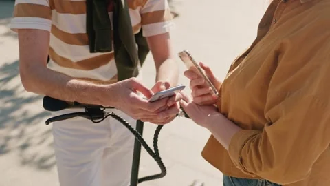 Close up shot of four human hands. Male and female hands holding smartphone Stock Footage 278910110