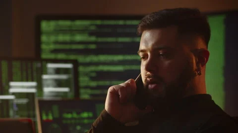 Close-up shot of a freelance programmer talking on the phone. A web programmer Stock Footage 236644636