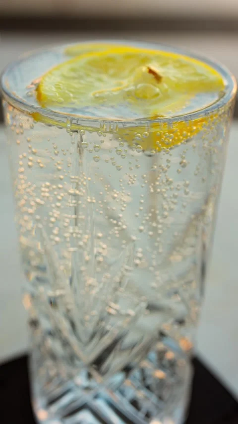 Close up shot of fresh drinking water with lemon slices, a refreshing drink.. Stock Footage 339753332