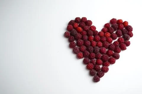 Close-up shot of a fresh raspberry in the shape of a heart - perfect for a blog Stock Photos