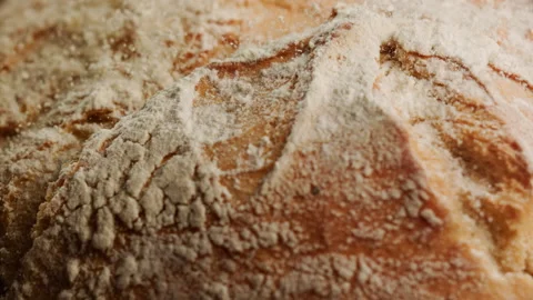 Close up shot of freshly baked bread falling in slow motion Stock Footage 153465693