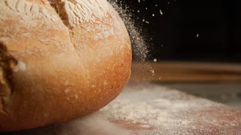 Close up shot of freshly baked bread falling in slow motion Stock Footage 153465763