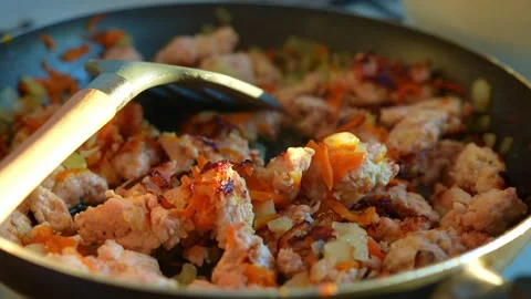 A close-up shot of freshly cooked minced meat with onions and carrots in a .. Video stock 345751097