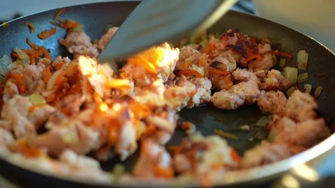 A close-up shot of freshly cooked minced meat with onions and carrots being.. Video stock 345751109