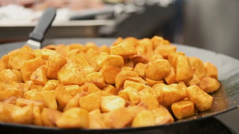 Close-up shot of fried potatoes roasting on the fire Stock Footage 194042748