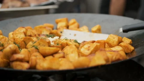 Close-up shot of fried potatoes roasting on the fire Stock Footage 194703822