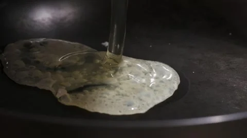 Close-up shot of frying egg in a pan Stock Footage 242419252
