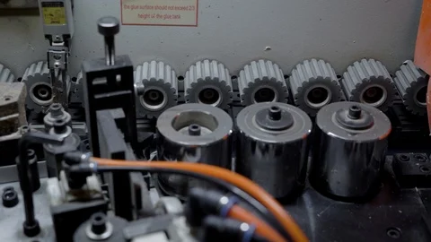 Close up shot of gears rotating in a edge banding machine. Video stock 92489358
