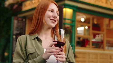 A close up shot of a ginger haired young woman, wearing a green blouse with a Video stock 160983232