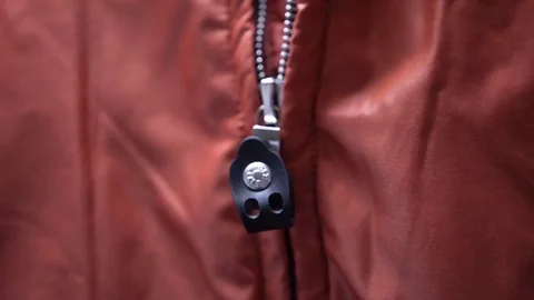 Close up shot of a girl pulling up zip on a red coat. Video stock 94841693