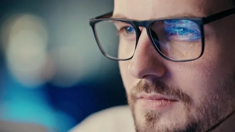 Close up shot glasses reflection statistcs how many bombs and rockets attacked Stock Footage 254854292