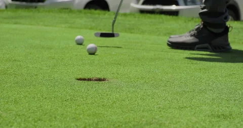 Close up shot of golf ball rolling into the hole. Golf player hitting a golf Stock Footage 247441852