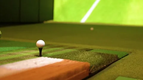 Close Up Shot of Golf Ball on Tee in Indoor Simulator Stock Footage 333300998