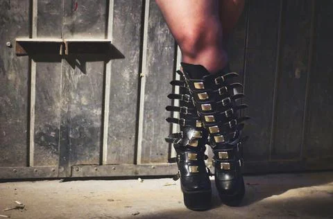 Close-up shot of gothic high leather boots with many straps and buckles Foto stock