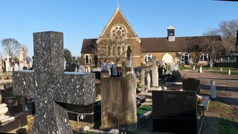 Close Up Shot of a Grave Stone of Cross Facing Cathedral. Stock Footage 300210955