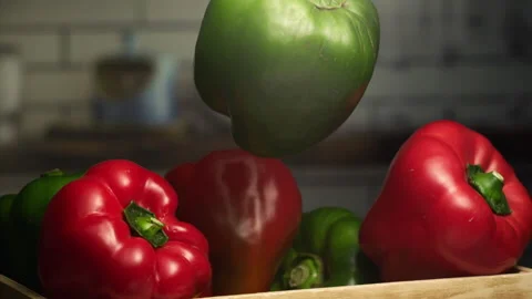 Close up shot of green pepper falling on a basket in slow motion Stock Footage 152902932