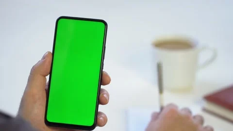 Close-up shot of green screen template smartphone in male hands at home offise Stock Footage 142793888