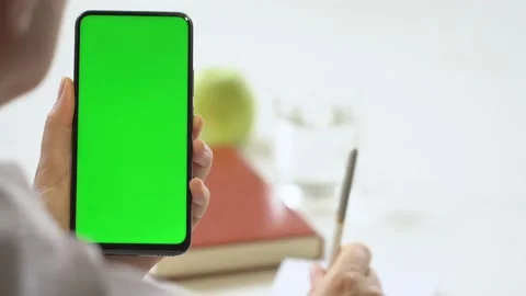 Close-up shot of green screen template smartphone in female hands at home offise Stock Footage 142874724