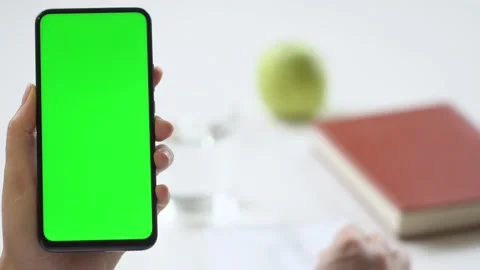 Close-up shot of green screen template smartphone in female hands at home offise Stock Footage 142877832