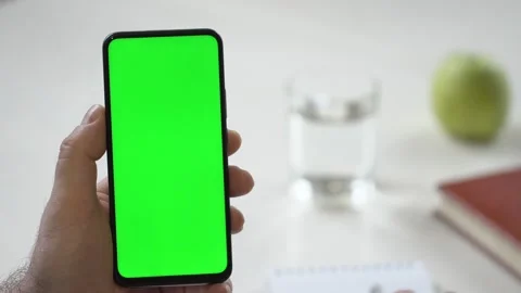 Close-up shot of green screen template smartphone in male hands at home offise Stock Footage 142877965