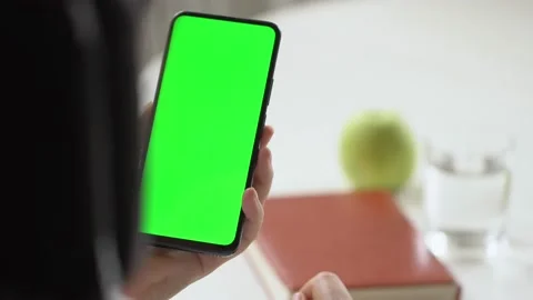 Close-up shot of green screen template smartphone in female hands at home offise Stock Footage 143008541