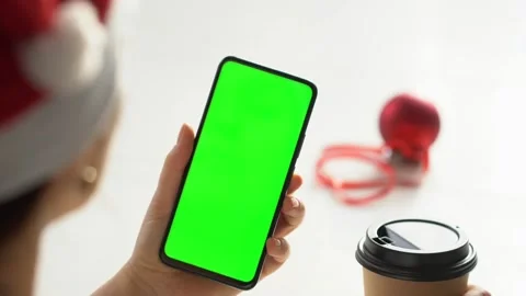 Close-up shot of green screen template smartphone in female hands at home offise Stock Footage 143588759