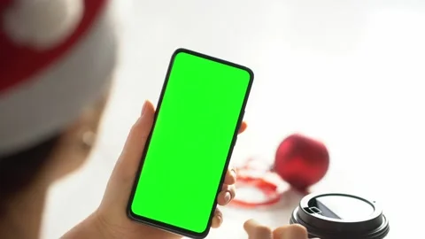 Close-up shot of green screen template smartphone in female hands at home offise Stock Footage 143589080