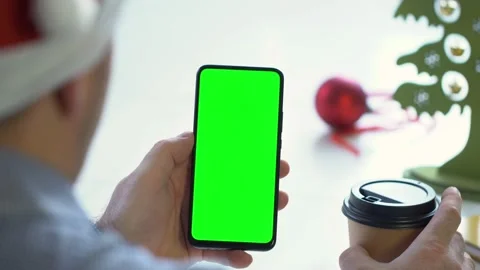 Close-up shot of green screen template smartphone in male hands at home offise Stock Footage 143589526