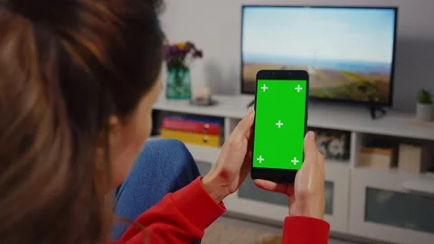 Close-up shot of green screen template smartphone in female hands at home, gi Stock Footage 156345485