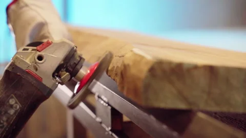 Close-up shot of grinding process in workshop, carpenter using angle machine for Video stock 265440284