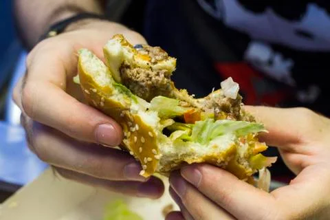 Close-up shot of guy eats burger  Foto stock